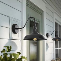 two outdoor lights on the side of a house