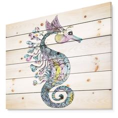 a seahorse painted on wooden planks is shown