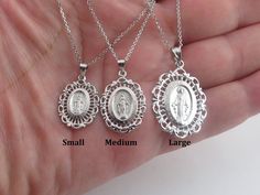 "A fabulous 14k white gold Virgin Mary charm pendant necklace!!  Cable Chain: by 1.1 mm thick with lobster clasp.  Material: 14k solid gold, Stamped on the clasp, Not plated. Small size measurements: 3/4\" long not including the bail by 5/8\" wide or 20 x 15 mm Length and avg weight: 16\"= 2.90  g 18\"= 3.20  g 20\"= 3.50 g Medium size measurements: 1\" or 24 mm long not including the bail by little over 5/8\" or 17 mm wide 16\"= 4.40 g 18\"= 5.00 g 20\"= 5.60 g  Large size measurements: 1\" or White Gold Pendant Charm Necklace With Lobster Clasp, Oval Sterling Silver Necklace With Lobster Clasp, Mother's Day White Gold Jewelry With Polished Finish, White Gold Jewelry With Lobster Clasp As Gift, Silver Charm Necklaces In Fine Jewelry Style, Sterling Silver Charm Necklace In White Gold, Silver Oval Jewelry With Lobster Clasp, Oval Jewelry With Lobster Clasp For Anniversary, Silver Oval Necklaces With Charms