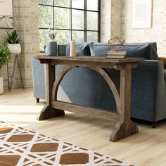 a living room with a blue couch and wooden table