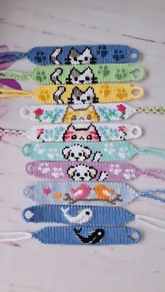 several bracelets with cartoon characters on them sitting on a wooden table next to scissors