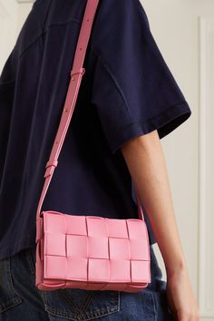 Part of the cult 'Cassette' family, Bottega Veneta's shoulder bag is made from double-faced strips of leather in the house's intrecciato weave - making the interior just as beautiful as the exterior. It has a zipped pocket and the strap is long enough to be worn cross-body. Designer Rectangular Shoulder Bag With Intrecciato Weave, Pink Rectangular Bag With Intrecciato Weave, Pink Intrecciato Weave Rectangular Bag, Luxury Pink Shoulder Bag With Intrecciato Weave, Pink Rectangular Woven Leather Shoulder Bag, Pink Crossbody Bag Outfit, Bottega Pouch, Bottega Veneta Cassette Bag, Crossbody Bag Outfit