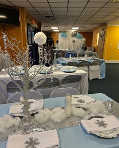 the tables are decorated with silver and white decorations