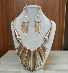 Introducing the Antique Beaten Metal Fringe Necklace Set with Earrings - a bold and distinctive piece of statement jewelry that resonates with the spirit of Arabic elegance and the allure of Native Tribal traditions. This unique necklace set is more than just an accessory; it's a captivating work of art that speaks to the soul. Color - Gold, Copper, Silver ❋❋ Shipping Methods ❋❋ Standard Delivery - Take up to 8-14 business days (Worldwide). ❋❋ Please be aware that the colors, shades, and texture Silver-colored Copper Jewelry For Parties, Unique Copper Jewelry For Parties, Silver Copper Jewelry For Party, Multicolor Jewelry With Matching Earrings, Multicolor Metal Teardrop Jewelry, Copper Dangle Jewelry For Party, Copper Dangle Party Jewelry, Bohemian Metal Necklace With Matching Earrings, Metal Dangle Jewelry Set With Matching Earrings