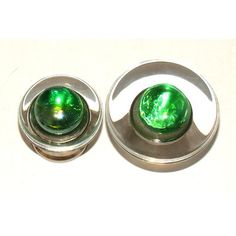 two green glass knobs are sitting next to each other