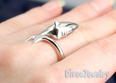 "This beautifully crafted sterling silver Shark is a beautiful replica of one of Nature's most amazing sea creatures and will surely draw attention to your love of the sea. Ring size: Fully adjustable to perfectly fit. If you know your ring size, please include it when ordering so your ring fits on arrival :-) Shark head size approx: 20mm x 9mm Band thickness : approx 1.4mm Band width: approx 2.6mm Weight: approx: 5grams Metal type: Solid 925 STERLING SILVER with Anti-Tarnish RHODIUM Finish Item Shark Ring, Enso Rings, Silver Shark, Shark Lover, Wrap Ring, White Sharks, Scuba Diver, Great White Shark, Statement Ring Silver