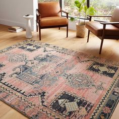 a living room filled with furniture and a large rug