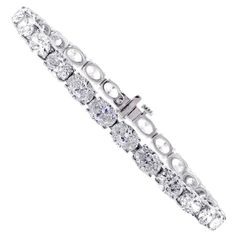 From Pampillonia jewelers, 27 perfectly matched oval diamonds lined up end to end form a straight line of diamonds. The 27 diamonds weigh 11.50 carats and are E-F color and are VS2+ clarity, set in 18 karat white gold. The bracelet is 6 ¾ inches and is available in any length. Pampillonia custom creates diamond bracelets in a variety of diamond shapes and sizes Luxury Oval Tennis Bracelet In Fine Jewelry Style, Luxury Oval Cubic Zirconia Bracelet, Oval Tennis Bracelet Diamond, Oval Bracelet Diamond, Oval Diamond Tennis Bracelet, Oval Diamond Bracelet, Wedding Jewellery Designs, Gold Diamond Watches, Flawless Diamond