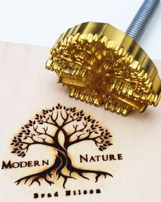 the logo for modern nature is displayed on a piece of paper with a metal clip