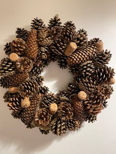 a pine cone wreath hanging on the wall