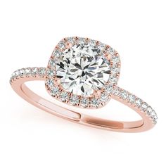 a yellow gold engagement ring with an oval halo setting and pave set diamonds around the band