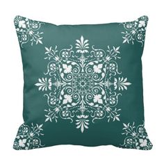 a green pillow with white flowers on it