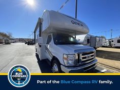 a white truck parked in front of a blue compass rv park