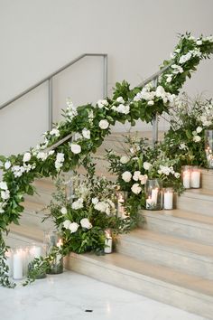 white flowers and greenery on the stairs