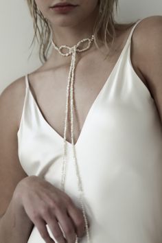 Not your grandma’s pearl necklace— asymmetrical strands of freshwater pearls are knotted into a choker for a dramatic yet iconic vintage moment. Editorial and glam— the perfect accessory to add a touch of fluidity and drama. #authentic #smallbusiness #readytowear #datenightinspo #datenightoutfit #accessories #boldearrings #aesthetic #nostalgicaesthetic Elegant Adjustable Pearl Necklace For Evening, Evening Pearl Choker Necklace, Elegant Adjustable Pearl Choker, Adjustable Pearl Embellished Choker Necklace, Elegant Pearl Beaded Lariat Necklace, Elegant Beaded Pearl Lariat Necklace, Evening Beaded Pearl Choker Necklace, Elegant Baroque Pearl Choker, Chic Beaded Necklace For Wedding