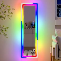 a brightly lit mirror in a living room next to a plant and window sill