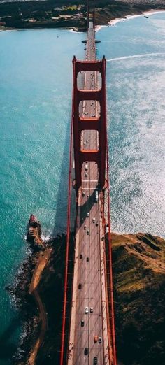 an aerial view of the golden gate bridge in san francisco, california with cars driving on it