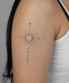 a woman's arm with a tattoo on it that has stars in the middle