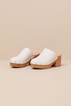 Step into the cutest style of the season with the Lulus Romain Bone Studded Platform Clogs! These wardrobe-essential clogs have a smooth, faux leather construction that shapes a rounded toe and a classic curved topline with an elastic gusset at the instep. Silver mirrored studs lends a hint of shine along the wood-look heel that carries into a 1"" toe platform. 3" wood-look block heel. Smooth insole. Rubber sole has nonskid markings. Man made materials. Imported. Lulus | Romain Bone Studded Plat White Platform Clogs For Spring, White Spring Platform Clogs, Summer Clogs With Contrasting Heel Counter And Round Toe, White Summer Clogs With Stacked Heel, Spring Synthetic Clogs With Stacked Heel, Spring Clogs With Contrasting Heel Counter And Round Toe, Spring Clogs With Contrasting Heel And Round Toe, White Clogs With Wooden Open Heel, White Open Toe Clogs With Stacked Heel