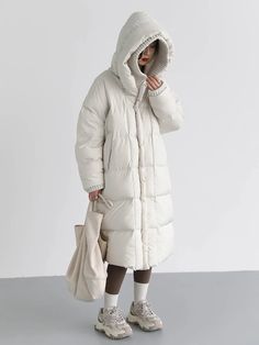 Material: 50% Polyester, 50% Nylon Step into winter with style in our Loose Hooded Long White Winter Jacket. This jacket combines the comfort of a loose fit with the elegance of a long silhouette, ensuring you stay cozy and fashionable. Embrace the season with confidence, wrapped in the warmth and versatility of this chic white winter jacket. Elevate your winter wardrobe with this timeless piece. Care: Machine Wash: Wash the jacket in cold water on a gentle cycle to preserve the fabric and color Solid Winter Parka With Fleece Lining, Winter Style Puffer Jacket With Fleece Lining, Winter Wear Puffer Jacket With Fleece Lining, Casual Winter Warm Puffer Jacket, Casual Warm Winter Puffer Jacket, Winter White Hooded Jacket With Detachable Hood For Fall, Winter White Parka With Detachable Hood For Fall, Winter White Hooded Parka With Pockets, Fall Hooded Jacket With Detachable Hood In Winter White