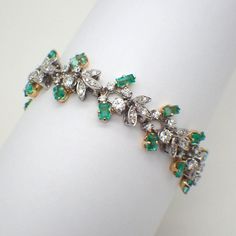 Vintage platinum bracelet, made of floral design links, encrusted with Diamonds. Each link is paired with two baguette-cut Emeralds set in 18k (.750) yellow gold.  Emeralds are approx. 4.8ctw, full and single cut diamonds are approx. 4ctw, SI clarity, color H-I. This stunning bracelet weighs 43.7 grams. EA3994 Elegant Diamond Bracelet With Jewels, Elegant Rose Cut Diamond Bracelets For Formal Occasions, Luxury Evening Bracelets With Baguette Diamonds, Luxury Yellow Gold Bracelets With Rose Cut Diamonds, Luxury Diamond Bracelet With Jewels, Luxury White Gold Bracelets With Rose Cut Diamonds, Elegant Green Diamond Bracelet With Accents, Formal Yellow Gold Diamond Bracelet With Rose Cut Diamonds, Formal Bracelets With Rose Cut Diamonds