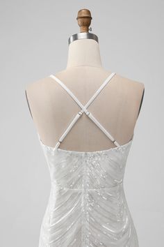 the back of a white wedding dress on a mannequin headdress with straps