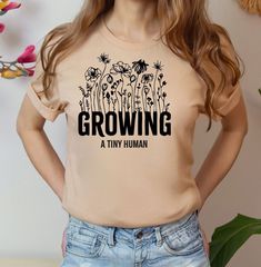 Growing A Tiny Human Shirt, Cute Pregnancy Announcement Shirt,, New Mom Gift, Baby Shower Gift For Mom, Funny Maternity T - Shirt -Our shirts are made to order specially for YOU. Please check our color and size charts before you place your order. If you have any questions please send us a message to clarify sizing or colors. - Please contact us via message box if you like to add or change anything on the design that's shown on the pictures to make sure if your request can be done or not. If you do not contact us for a request before you order, we do not guarantee extra request to be done and send the items as shown in the pictures. - Please check the color charts for the size and type of the t-shirt you like, not every color is available for each type of t-shirt, drop down comes automatica Baby Shower Gift For Mom, Funny Maternity, Cute Pregnancy Announcement, Mom Funny, Pregnancy Announcement Shirt, Types Of T Shirts, Pregnancy Humor, Pregnancy Tshirts, New Mom Gift