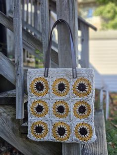 Gorgeous handmade Sunflower Tote with brown faux leather handles! This tote is fully lined in canvas- you will never lose items out of those granny-square holes! An added metal button keeps your stuff secure (see photo!) All measurements are approximate! The shoulder strap drop is 9.5 inches long. There are two faux leather handles in brown that are not adjustable. The perfect length to tuck and go. The bag itself is 13 inches wide and 14 inches long. The bottom measures 2.5 inches across- very roomy! The primary background color is a beautiful oatmeal displayed around mustard yellow sunflower petals. Very neutral, will match a lot! Yellow Square Bohemian Bag, Bohemian Yellow Square Bag, Yellow Granny Square Crochet Bag, Sunflower Tote Bag Crochet, Rectangular Everyday Bag With Sunflower Print, Yellow Sunflower, Crochet Tote, Mustard Yellow, Metal Buttons