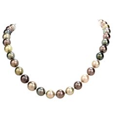 This very high quality lustrous South Sea peacock pearl and diamond strand necklace, weighs 80 grams and measures 19 inches long. Composed of 39 various colored creme to dark grey high quality AAA South Sea peacock pearls, ranging from 12mm - 10mm in diameter. Accented by one round 18k gold diamond pave set clasp set with round cut diamonds, weighing approximately, 1.65 carats, graded H-I color and VS and few SI clarity. Secures with a well concealed tongue in groove clasp. Remains in excellent Pinterest Jewelry, South Sea Pearl Necklace, Peacock Pearls, Tahitian Pearl Necklace, Peacock Pearl, Heart Choker Necklace, Beautiful Pearl Necklace, Pearl Chain Necklace, Cultured Pearl Necklace