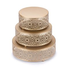 three tiered gold metal cake stand with intricate designs on the top and bottom layer