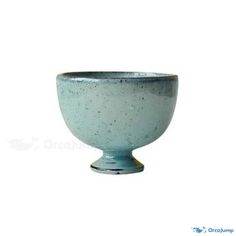 a small blue bowl sitting on top of a white table