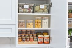 an organized pantry with jars and spices