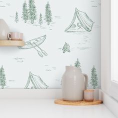 there is a wallpaper with a camp scene on it and a mug next to it