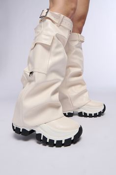 The AZALEA WANG Ezrah White Boot is a flatform sneaker boot hybrid featuring a faux leather upper, a fold-over knee-high shaft, a belted design, and a slightly covered platform rubber lug sole. Complete with functional cargo side pockets, a pull-on fit, and silver metallic hardware accents. (all measurements approximate from a size 7.5) - DenimTextile Upper - Square Toe - Flatform Wedge Sole - 16” Shaft Height - 19” Shaft Opening Circumference - 13” Calf Circumference  - 2.25” Flatform Sole Height - 3” Chunky Heel Height - Imported Product ID: 387453 Futuristic Boots, Futuristic Shoes, Fold Over Boots, Flatform Sneakers, Azalea Wang, Cheap Womens Clothing, White Boots, Cheap Clothes, Lug Sole