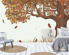 a bedroom with a tree mural on the wall