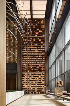 an empty lobby with lots of windows and chairs