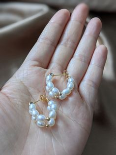 These Freshwater pearl double hoop earrings on 14k gold studs/Small pearl hoop earrings/White pearl earrings/Birthday gift/Gift for her are so cute and elegant. They are made with 12 4-5mm rice-shaped freshwater pearls strung to the 14k gold studs. The safety back is also 14k gold, so it won't tarnish easily. The earrings are approximately 0.75 inches in diameter. It is a wonderful gift for yourself and your loved one. Free domestic shipping is included. If you want single hoop pearl earrings, y Cheap Earrings With Pearl Charm, Cheap Pearl White Earrings With Pearl Charm, Cheap Pearl Beaded Earrings With Round Beads, Dainty Yellow Gold Hoop Earrings With Pearl, Pearl Huggie Earrings For Anniversary, Pearl Huggie Jewelry For Anniversary, Yellow Gold Hoop Earrings With Pearl Charm As Gift, Everyday Round Hoop Earrings With Pearl Chain, Dainty Pearl Huggie Earrings