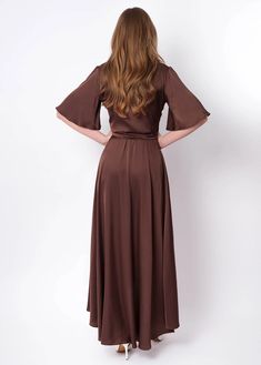 the back view of a woman in a brown dress