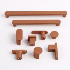 an assortment of brown plastic objects on a white surface