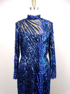 "This is a GORGEOUS Bob Mackie couture evening gown with exquisite detailing! It's in perfect condition! Bust - 36\" Waist - 30\" Hips - 40\" Dress Length - 57\" This dress comes from a pet-free and smoke-free home. If you would like more info or have any questions, please don't hesitate to ask!" Blue Embellished Sequin Dress For Gala, Blue Embellished Cocktail Gown, Embellished Blue Cocktail Gown, Blue Embellished Gown For Cocktail, Cocktail Embellished Blue Gown, Blue Hand Embellished Formal Gown, Blue Hand Embellished Gown For Formal Occasions, Formal Blue Hand Embellished Gown, Blue Sequined Cocktail Gown