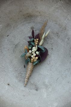 a dried flower on the ground in a bowl