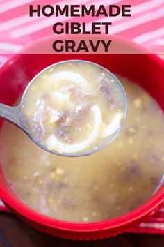 a spoon full of homemade giblet gravy in a red bowl with text overlay