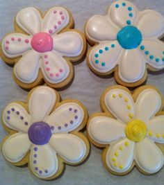 decorated cookies are arranged in the shape of flowers