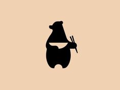 a black bear holding chopsticks in its paws