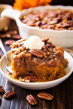 a slice of pecan pie on a plate with a fork and bowl of pecans in the background