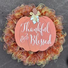 a pumpkin wreath with the words, thank and blessed written on it