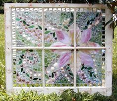 a glass window with flowers and pearls on it