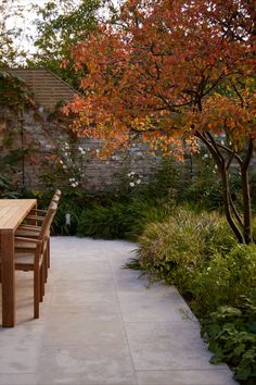 a wooden table sitting on top of a patio