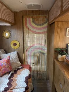 a small bedroom with a bed, dresser and window in the wall next to it