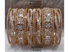 Elevate your bridal look with this gold and silver-tone CZ stone-inspired bridal chura set, featuring cubic zirconium and American diamond stones. Perfect for brides and bridesmaids, these bangles add elegance with colorful crystal stones. cz bangles Indian, cz stones white bangles, cz diamond bracelet, ruby bangles cz Indian, and diamond cut bangles. Bangles  Sizeable Gold and Silver Tone , Crystal Stone , AD , CZ , Stone , Bead *PERFECT GIFT FOR YOUR LOVED ONES* *FOR ANY QUERIES AND INFORMATIO Gold Cubic Zirconia Bridal Accessories As Gift, Gold Cubic Zirconia Bridal Accessories For Gift, Wedding Diamond Baguette Cut Bangle, Wedding Diamond Bangle With Baguette Cut, Gold Hand Set Bridal Accessories For Reception, Luxury Gold Bridal Sets With Cubic Zirconia, Luxury Gold Cubic Zirconia Bridal Sets, Baguette Cut Jewelry With Sparkling Stones For Wedding, Dazzling Baguette Cut Bracelet For Wedding